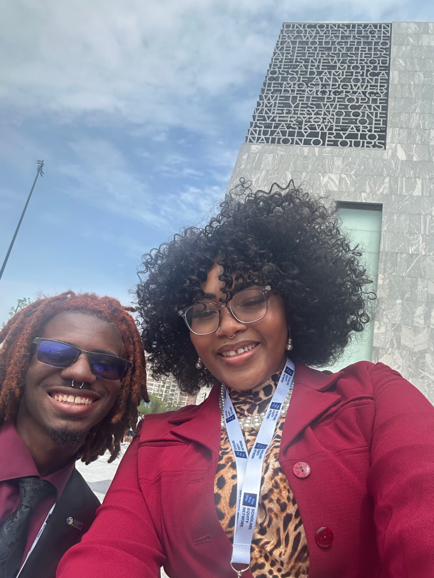 Two members of the project team smile together outdoors.